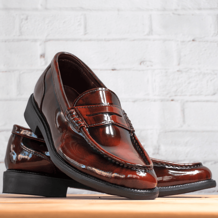 Men's loafers in various styles, including casual slip-ons and formal loafers, displayed on a sleek, minimalist background in classic black, brown, and tan colors.