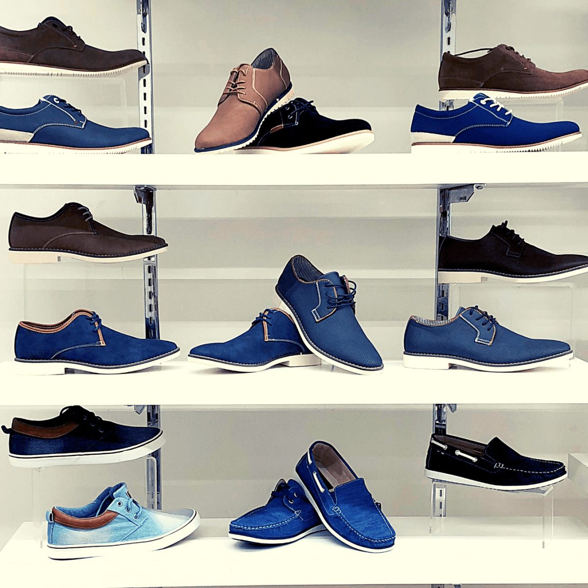 Selection of men's shoes including sneakers, boots, loafers, and formal shoes, displayed on a sleek minimalist background.