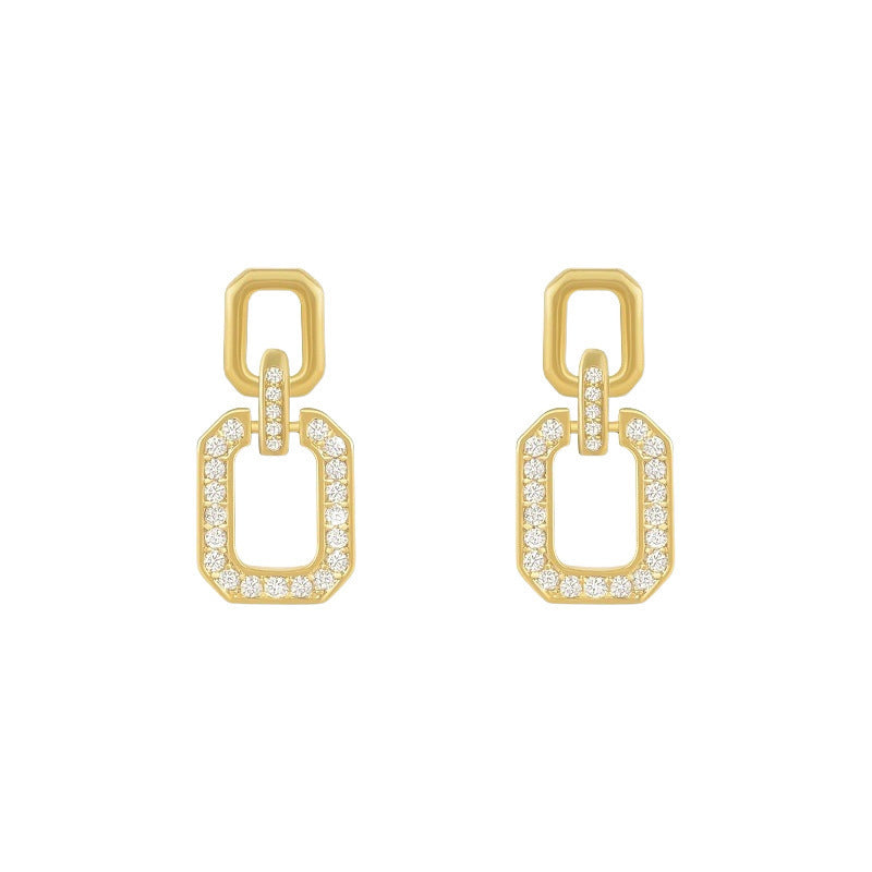 Gold earrings with diamond accents on a white background