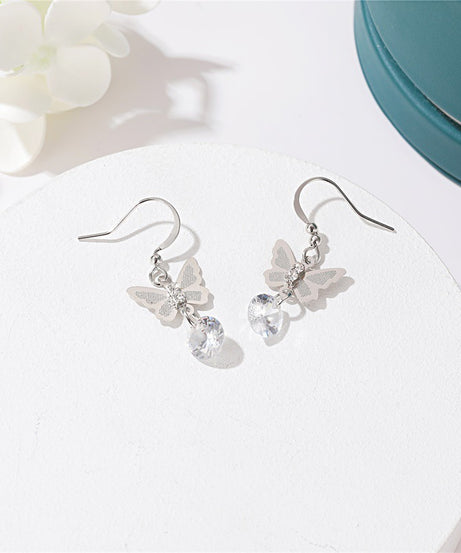 Butterfly crystal drop earrings in silver on white tray