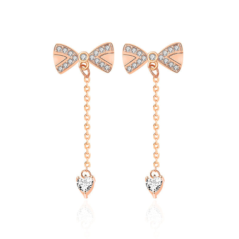 Close-up bow tassel studs with pavé heart