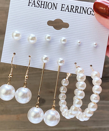 Detail of gold hoop earrings with pearl accents.2