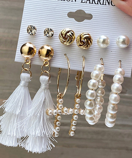 Detail of gold hoop earrings with pearl accents.3