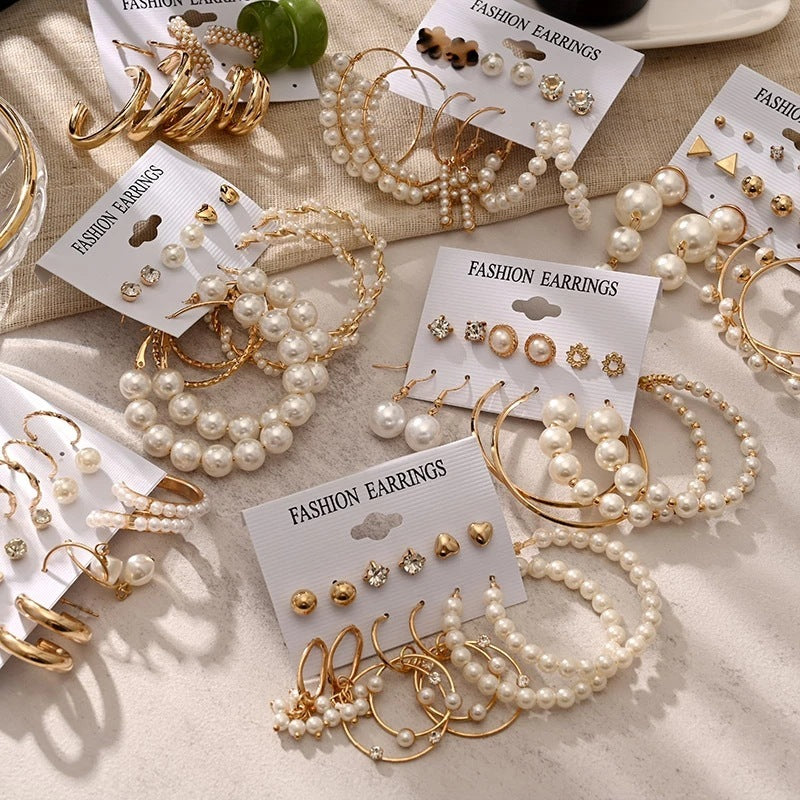 Gold hoop and stud earring set with faux pearls and crystals — 6 pairs on card.