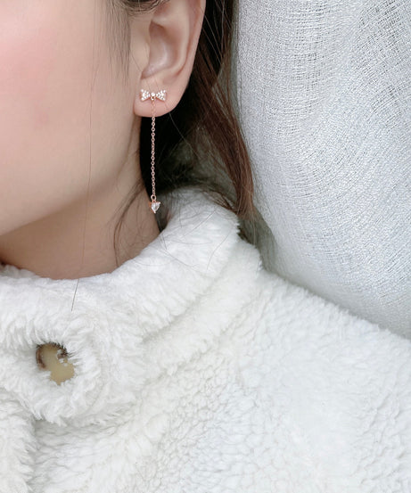 Model wearing rose-gold bow tassel drop stud earrings