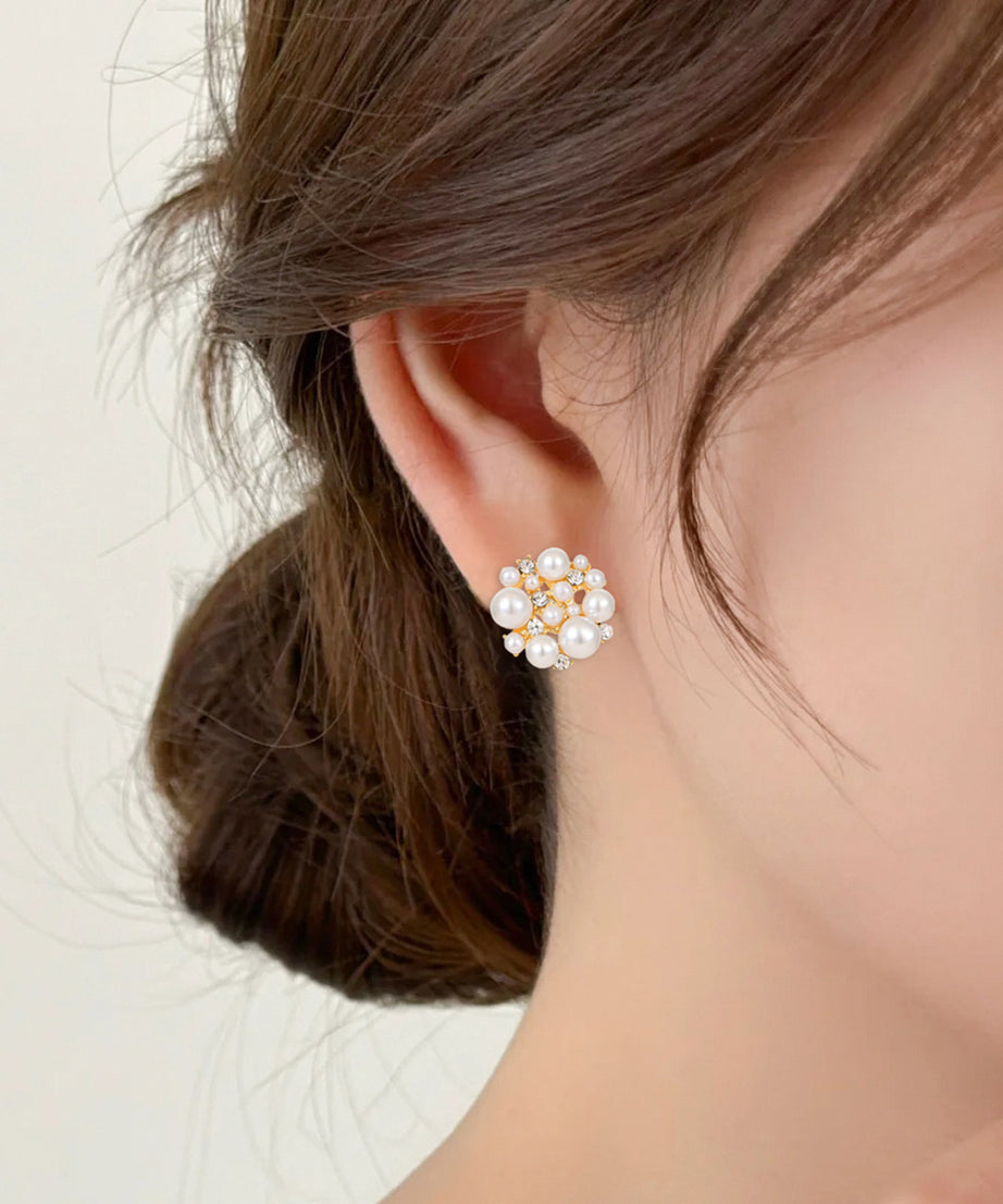 Pearl earring worn by a person with a neutral background