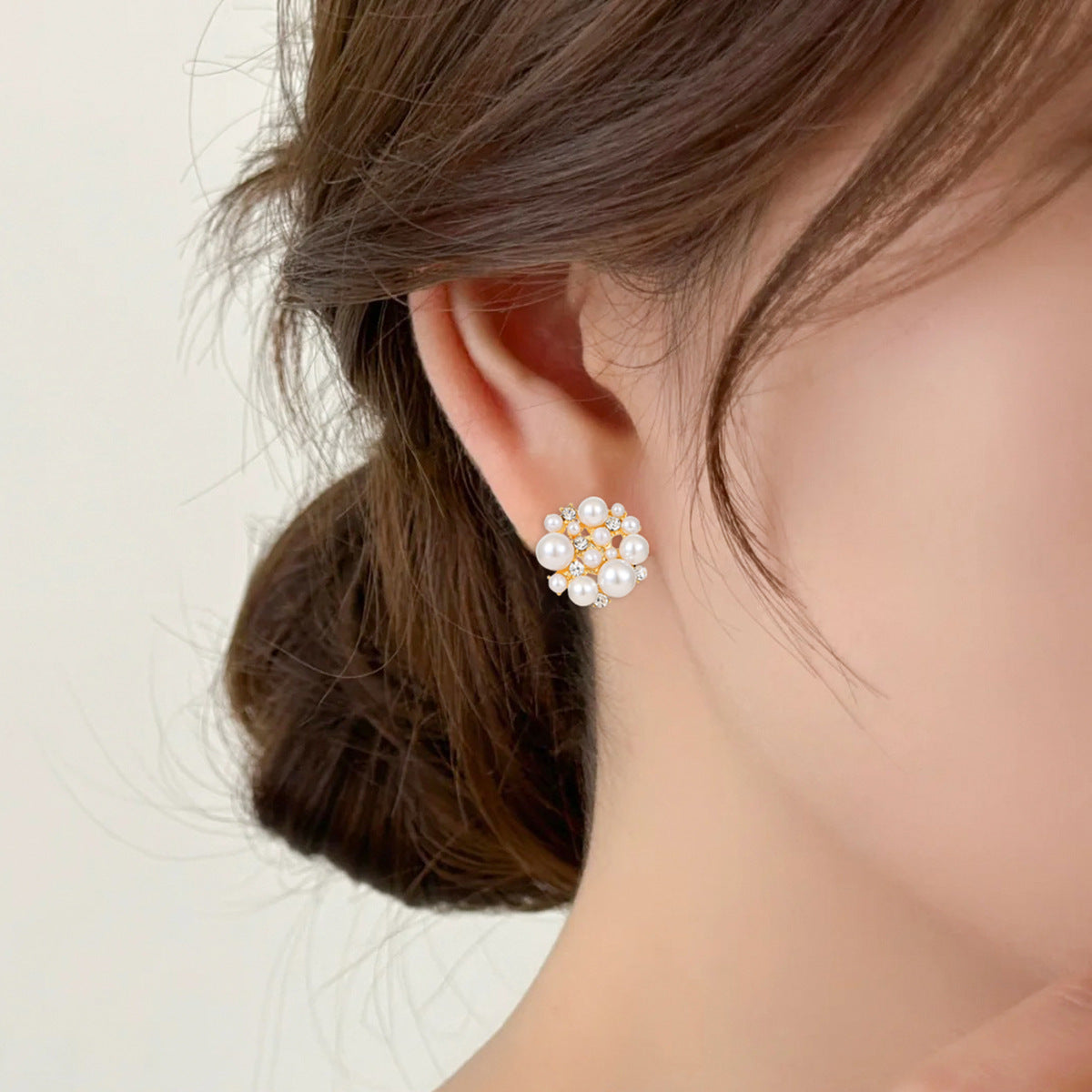 Pearl earring worn by a person with a neutral background