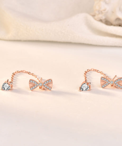 Side and back view of bow tassel stud earrings, rose-gold tone